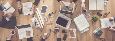 Desk with laptops and paper