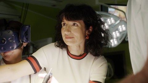 Close-up of Professor Speidel. In the background on the right an operating lamp