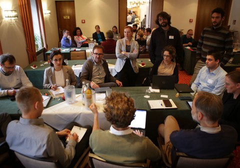 Group of people sitting around a table and talking